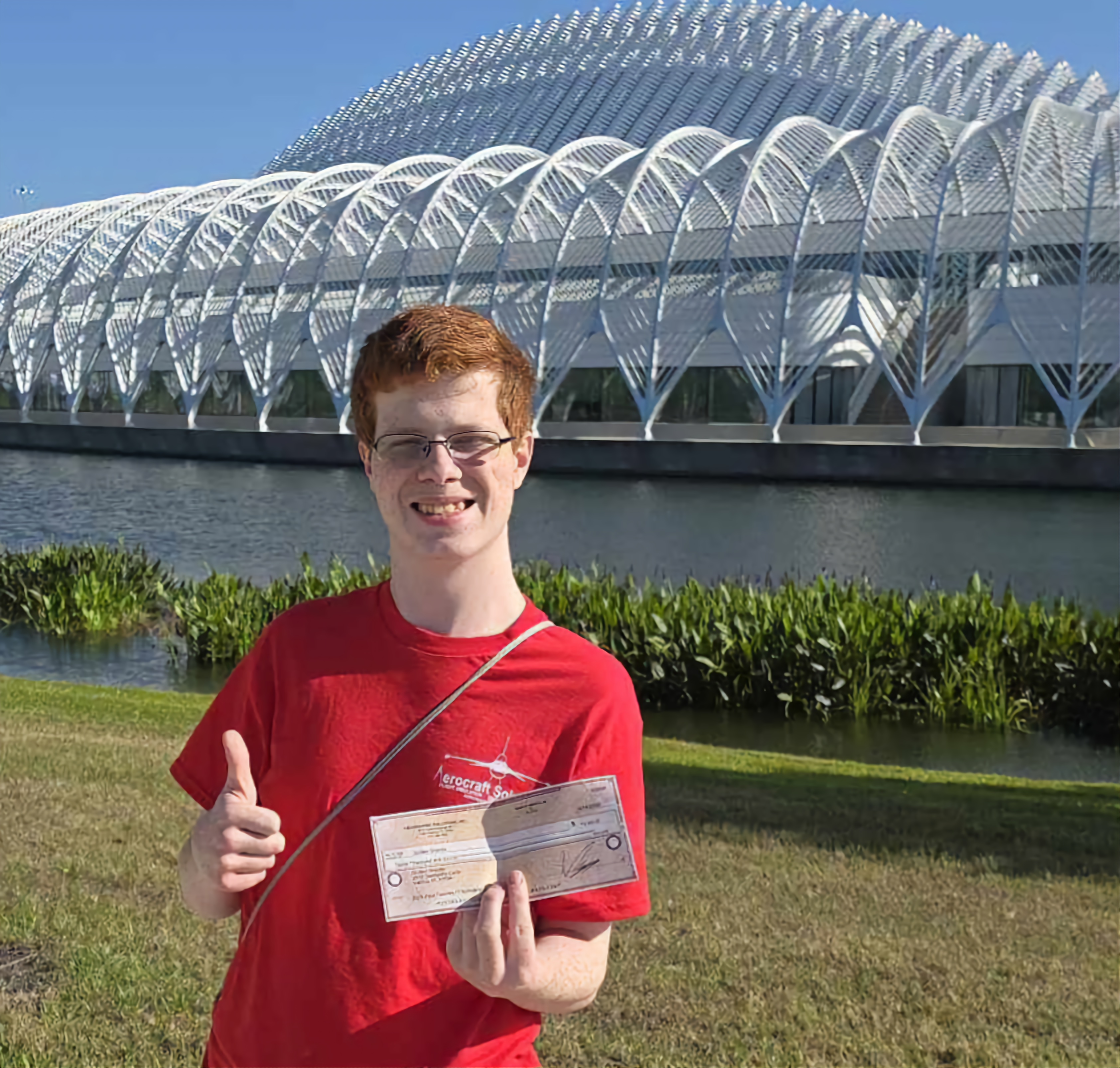 Quillen Shields holding IT Scholarship Award check